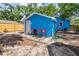 Exterior of the blue house featuring chairs on the concrete patio in the backyard at 4411 3Rd S Ave, St Petersburg, FL 33711