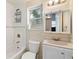 Bright bathroom featuring a shower-tub combo with a tiled shower, vanity with sink, and a window at 4411 3Rd S Ave, St Petersburg, FL 33711