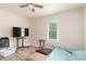 Bedroom with neutral walls, updated flooring, and a standard single door closet and large TV at 4411 3Rd S Ave, St Petersburg, FL 33711