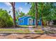 Charming blue bungalow with brick street and mature trees creating a picturesque setting at 4411 3Rd S Ave, St Petersburg, FL 33711