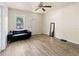 Cozy room with a modern black sofa, sleek mirror, and light-colored flooring at 4411 3Rd S Ave, St Petersburg, FL 33711