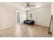 Bright living room with light floors, a modern sofa, and a classic ceiling fan at 4411 3Rd S Ave, St Petersburg, FL 33711