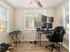 Functional office with multiple monitors, neutral walls, and natural light from a window at 4411 3Rd S Ave, St Petersburg, FL 33711