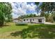 Spacious backyard with a trampoline, patio, and well-maintained lawn at 5206 Cindy Kay Dr, Plant City, FL 33566