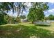 Landscaped backyard with play equipment and shed at 5206 Cindy Kay Dr, Plant City, FL 33566