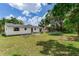 Expansive backyard featuring a trampoline, patio set, and well-maintained lawn at 5206 Cindy Kay Dr, Plant City, FL 33566