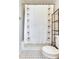 Neutral bathroom featuring a decorative shower curtain and black and white tile floor at 5206 Cindy Kay Dr, Plant City, FL 33566