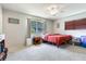 Bright bedroom with a comfortable bed, ceiling fan, and ample natural light, creating a serene and inviting space at 5206 Cindy Kay Dr, Plant City, FL 33566