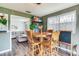 This dining area features a wooden table with chairs and a decorative chalkboard, perfect for Gathering meals and creativity at 5206 Cindy Kay Dr, Plant City, FL 33566