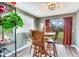 Cozy dining room featuring a wooden table with chairs and a view of the backyard at 5206 Cindy Kay Dr, Plant City, FL 33566