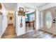 Entryway hallway featuring wood floors, light colored walls, and office access at 5206 Cindy Kay Dr, Plant City, FL 33566