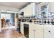 Bright kitchen with white cabinets, diamond-patterned backsplash, and stainless steel appliances at 5206 Cindy Kay Dr, Plant City, FL 33566