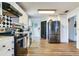 Spacious kitchen featuring wood floors, stainless steel appliances, and ample cabinet space at 5206 Cindy Kay Dr, Plant City, FL 33566
