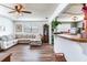Inviting living room featuring an L shaped couch, wood floors, and an open layout at 5206 Cindy Kay Dr, Plant City, FL 33566