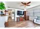 A spacious living room features modern furnishings, seamlessly connecting to the hallway, enhancing the home's open feel at 5206 Cindy Kay Dr, Plant City, FL 33566