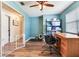 This home office features wood floors, a large desk, and ample storage, perfect for a productive work environment at 5206 Cindy Kay Dr, Plant City, FL 33566