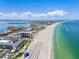 Breathtaking beach view of a condo with clear blue skies and beautiful shoreline in the distance at 5353 Gulf Blvd # A402, St Pete Beach, FL 33706