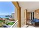 This spacious balcony has seating with views of tropical landscaping, waterways, and the intercoastal at 5353 Gulf Blvd # A402, St Pete Beach, FL 33706