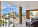 Spacious balcony showcasing seating, with scenic views of the neighborhood and a partial ocean view at 5353 Gulf Blvd # A402, St Pete Beach, FL 33706