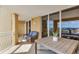 Outdoor balcony area with comfortable seating and sliding glass doors at 5353 Gulf Blvd # A402, St Pete Beach, FL 33706