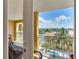 View from balcony overlooking pool, palms, and waterfront community at 5353 Gulf Blvd # A402, St Pete Beach, FL 33706