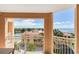 A cozy balcony offers water views, sunshine and shade, and overlooks the red tile roofs of the neighborhood at 5353 Gulf Blvd # A402, St Pete Beach, FL 33706