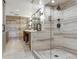 Luxurious bathroom featuring a frameless glass shower, dual vanity, and modern fixtures with a marble design at 5353 Gulf Blvd # A402, St Pete Beach, FL 33706