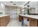 Elegant bathroom with double sinks, quartz countertop, wooden cabinets, and a frameless walk-in glass shower at 5353 Gulf Blvd # A402, St Pete Beach, FL 33706