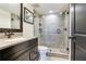 Contemporary bathroom with glass-enclosed shower and modern vanity at 5353 Gulf Blvd # A402, St Pete Beach, FL 33706
