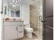 Nicely updated bathroom featuring a glass walk-in shower, neutral tile, and updated cabinets and lighting at 5353 Gulf Blvd # A402, St Pete Beach, FL 33706
