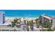 Scenic view of the beach and ocean from beachfront condo with palm trees and resort-style amenities at 5353 Gulf Blvd # A402, St Pete Beach, FL 33706