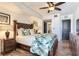 Comfortable bedroom features a ceiling fan, hardwood floors, and nightstands at 5353 Gulf Blvd # A402, St Pete Beach, FL 33706