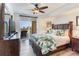 Inviting bedroom features a ceiling fan, hardwood floors, and sliding glass doors to balcony with ocean view at 5353 Gulf Blvd # A402, St Pete Beach, FL 33706