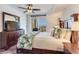 Bright bedroom boasts wood flooring, a ceiling fan, and balcony access for stunning views at 5353 Gulf Blvd # A402, St Pete Beach, FL 33706