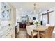 Dining area with hardwood floors, a dining table, and living area in the background at 5353 Gulf Blvd # A402, St Pete Beach, FL 33706