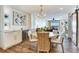 Elegant dining room with a kitchen in the background, wine storage, and a modern chandelier at 5353 Gulf Blvd # A402, St Pete Beach, FL 33706