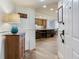 Entryway of home featuring wood floors, updated lighting, and open floor plan to kitchen at 5353 Gulf Blvd # A402, St Pete Beach, FL 33706