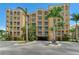 Multi-story beachfront condo building with palm trees, stucco exterior, and balconies at 5353 Gulf Blvd # A402, St Pete Beach, FL 33706