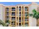 Beautiful building featuring multiple balconies, archways, and a red tiled roof at 5353 Gulf Blvd # A402, St Pete Beach, FL 33706