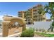 Elegant Bella Grande condo building featuring multiple floors with private balconies and lush landscaping at 5353 Gulf Blvd # A402, St Pete Beach, FL 33706