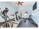 Well-equipped gym with an elliptical, treadmill, weights, and mounted TV at 5353 Gulf Blvd # A402, St Pete Beach, FL 33706