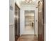 Hallway view showcasing the ensuite bathroom with glass shower and vanity at 5353 Gulf Blvd # A402, St Pete Beach, FL 33706