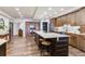 Open kitchen layout featuring hardwood floors, stainless steel appliances, and a center island with seating at 5353 Gulf Blvd # A402, St Pete Beach, FL 33706