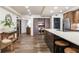 Spacious kitchen featuring hardwood floors, stainless steel appliances, and a center island with seating at 5353 Gulf Blvd # A402, St Pete Beach, FL 33706