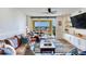 Open living room design includes hardwood floors, comfortable seating, and a private balcony overlooking the water at 5353 Gulf Blvd # A402, St Pete Beach, FL 33706