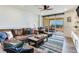 The open living room is furnished with hardwood floors, a large sectional sofa, and balcony access at 5353 Gulf Blvd # A402, St Pete Beach, FL 33706