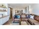 Bright living area showcasing an open floorplan, wood floors, and modern furnishings at 5353 Gulf Blvd # A402, St Pete Beach, FL 33706