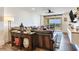 Open living room with a leather sofa, wood floors, entertainment center and balcony access with beautiful water views at 5353 Gulf Blvd # A402, St Pete Beach, FL 33706