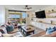 Open living room featuring hardwood floors, modern furniture, built-in storage, and a private balcony at 5353 Gulf Blvd # A402, St Pete Beach, FL 33706