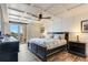 Bedroom with coffered ceilings, an exterior balcony, and wooden floors at 5353 Gulf Blvd # A402, St Pete Beach, FL 33706